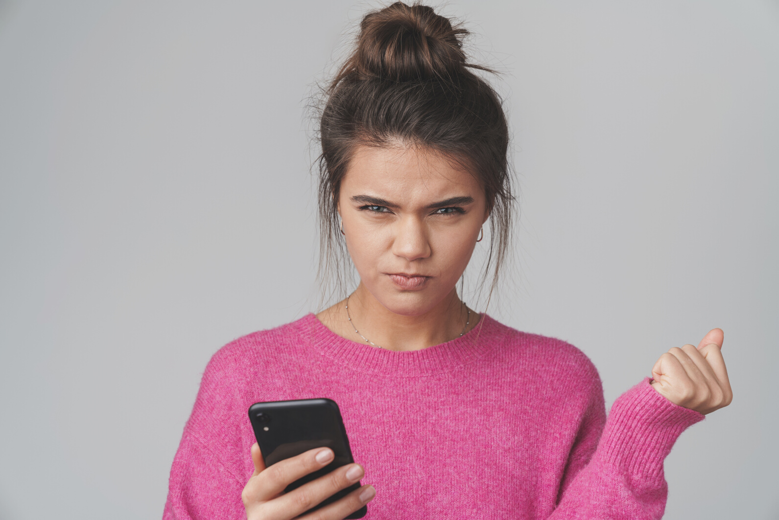 Woman Looks Annoyed as She Uses Cellphone 