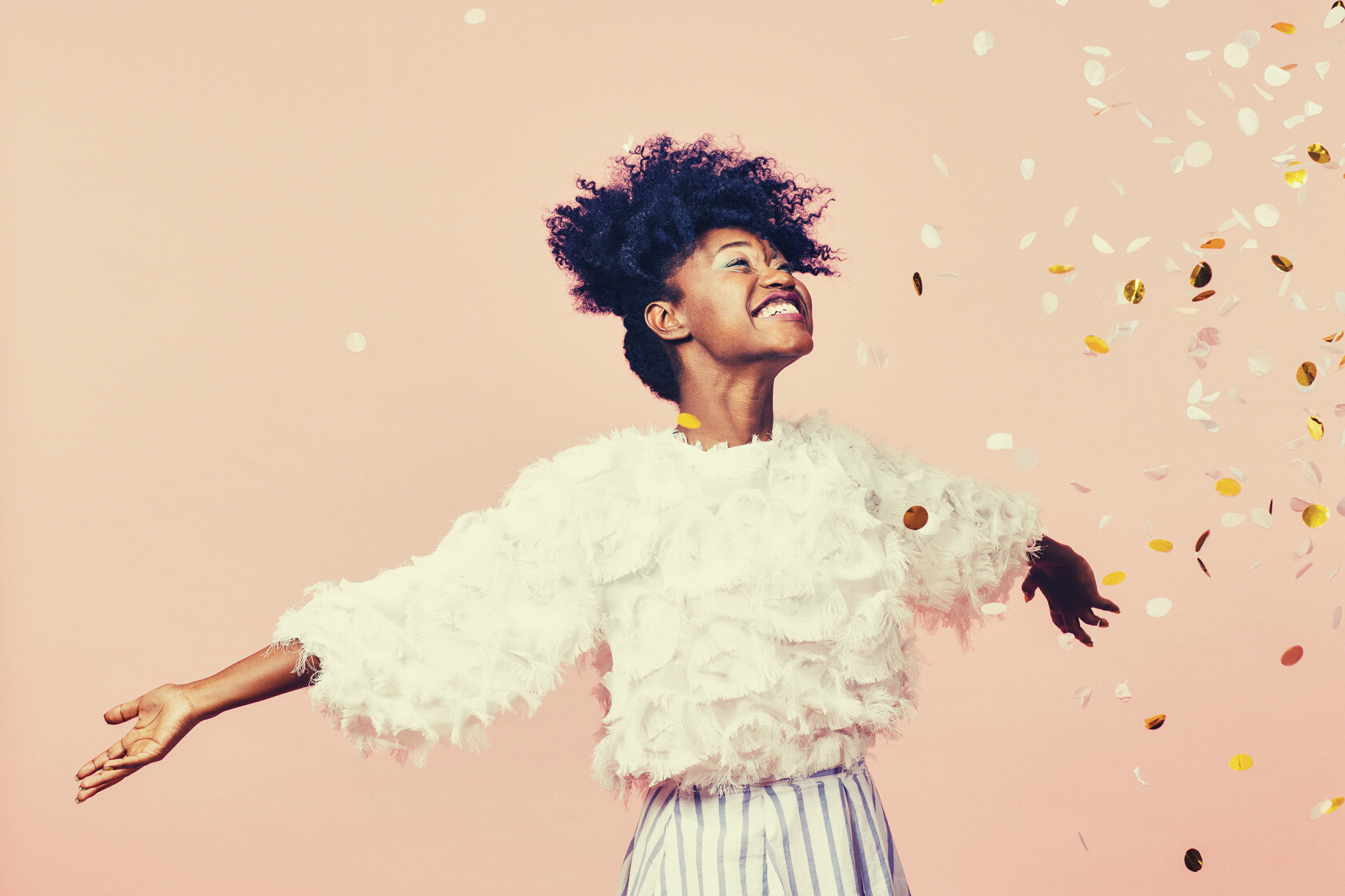 Celebrate happiness and joy- young girl throwing confetti